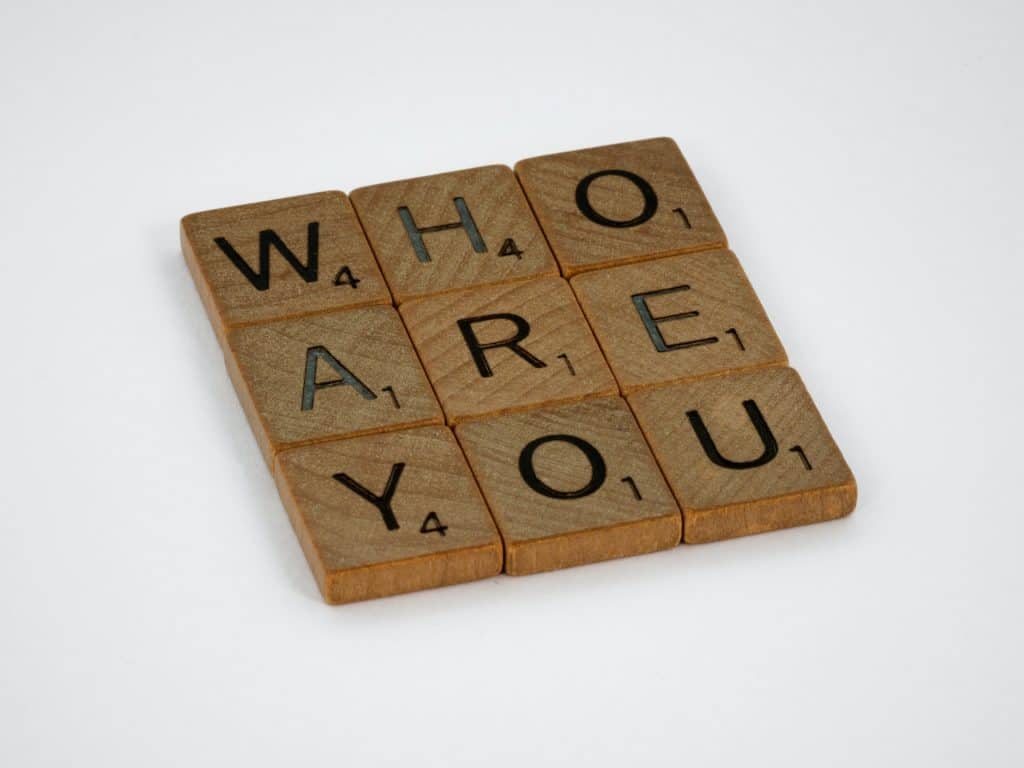 Pictured are scrabble block letters in shape of a square 3 by 3 that reads "Who are you". Today's episode is 5 Leadership Principles: Conversation with Paul Hanson, President of Epcon Franchising